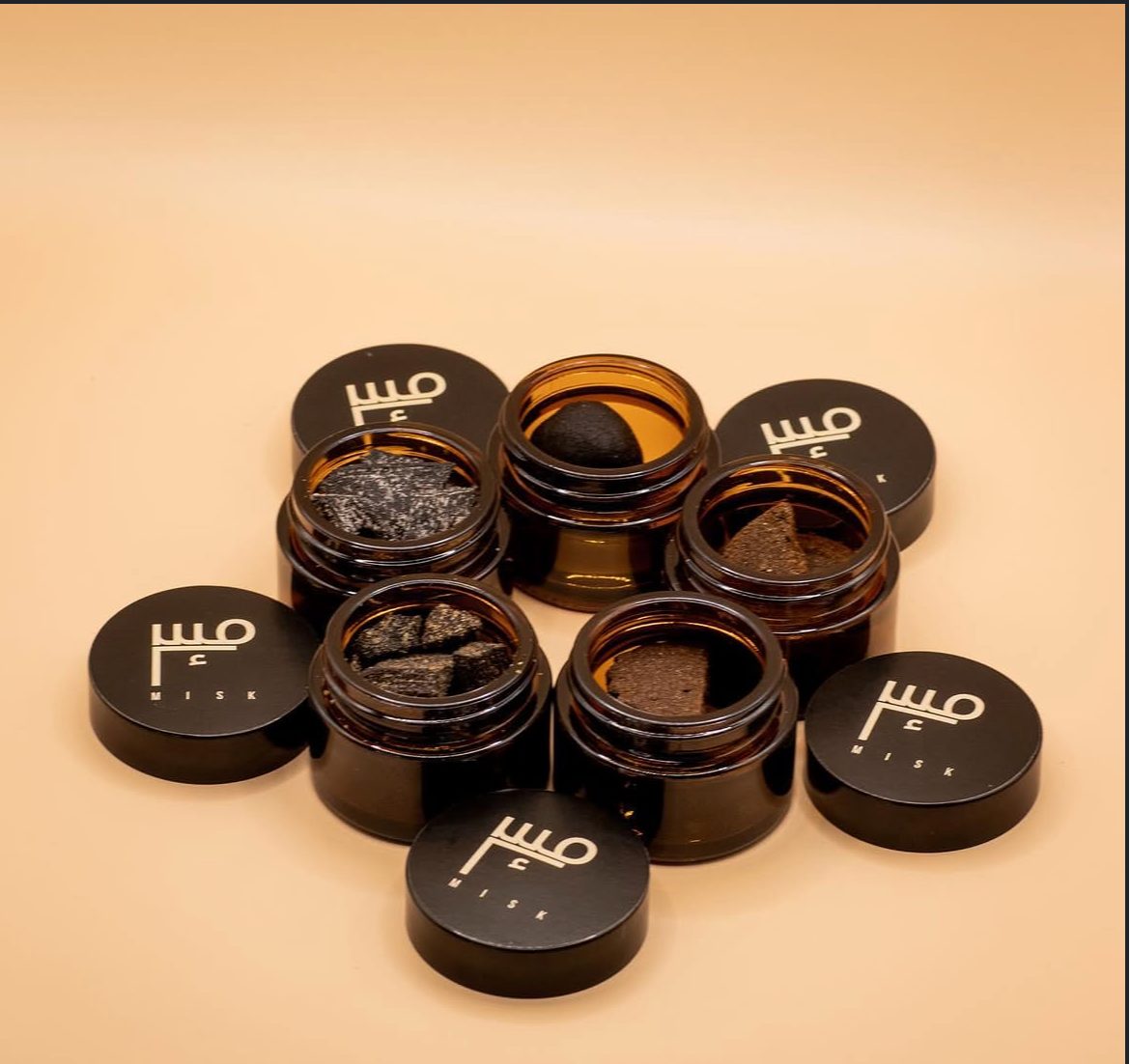 Open mini jars of hand-crafted misk incense