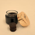 Tafas handmade bakhoor — three pieces stacked beside the jar