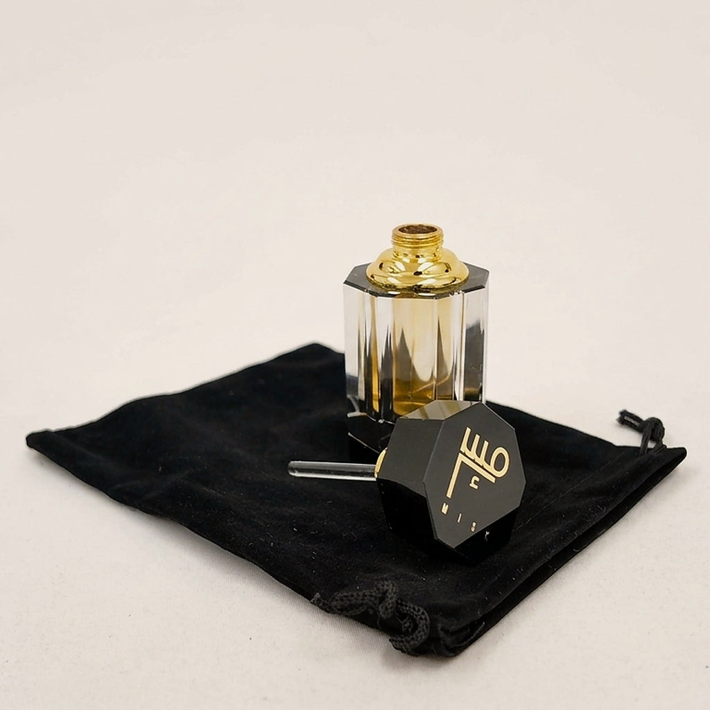 Taybah concentrated perfume oil with the cap off, glass applicator showing