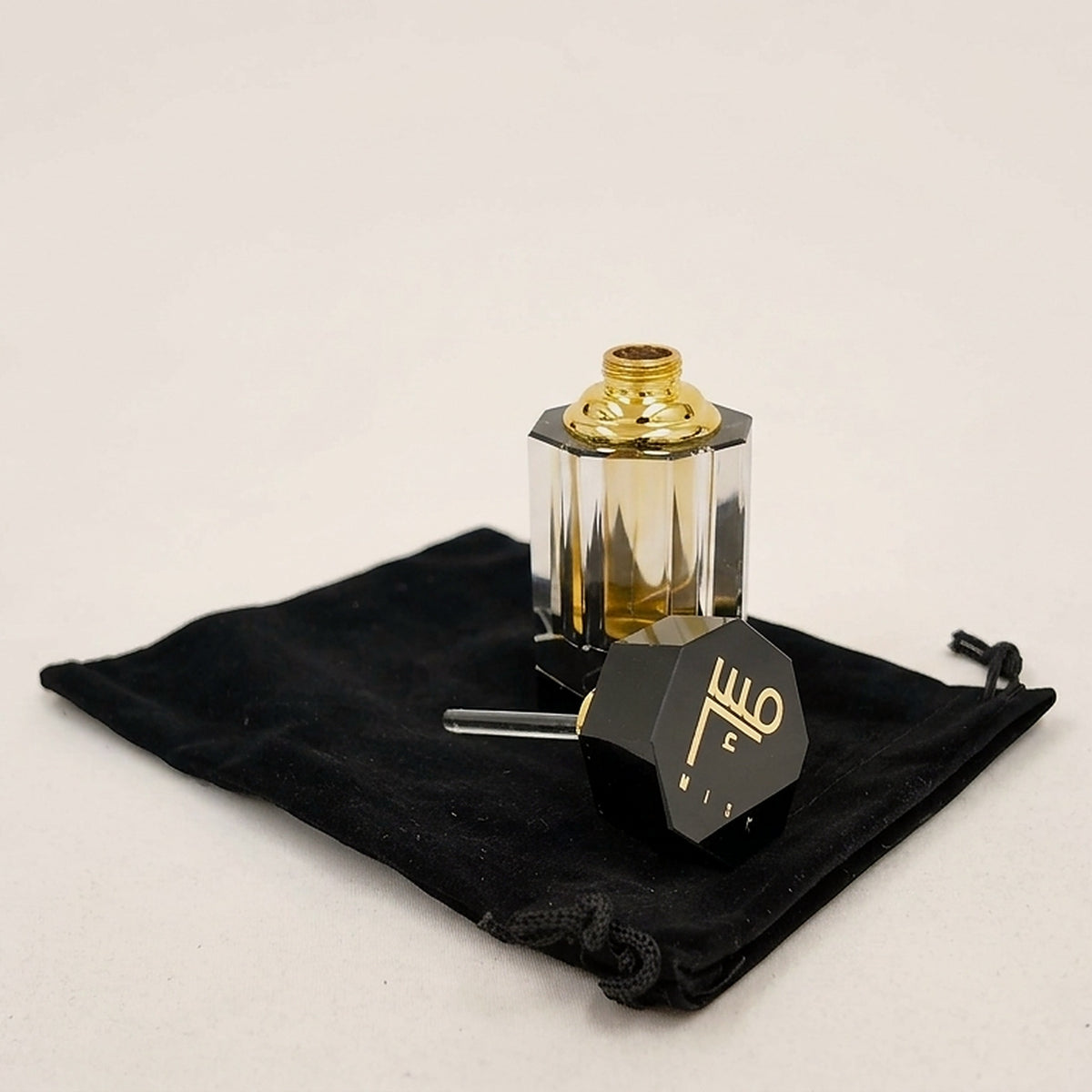 Taybah concentrated perfume oil with the cap off, glass applicator showing